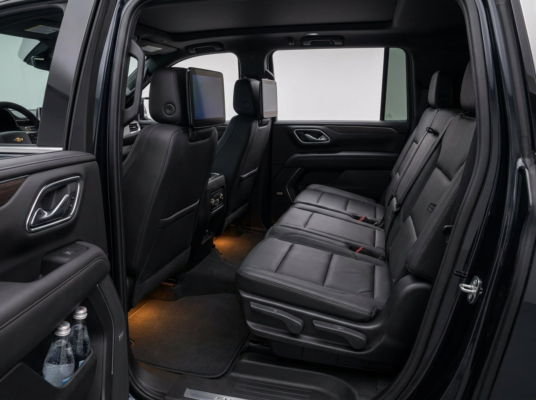 Interior of the Chevrolet Suburban, black leather three-across second-row bench and cabin detail